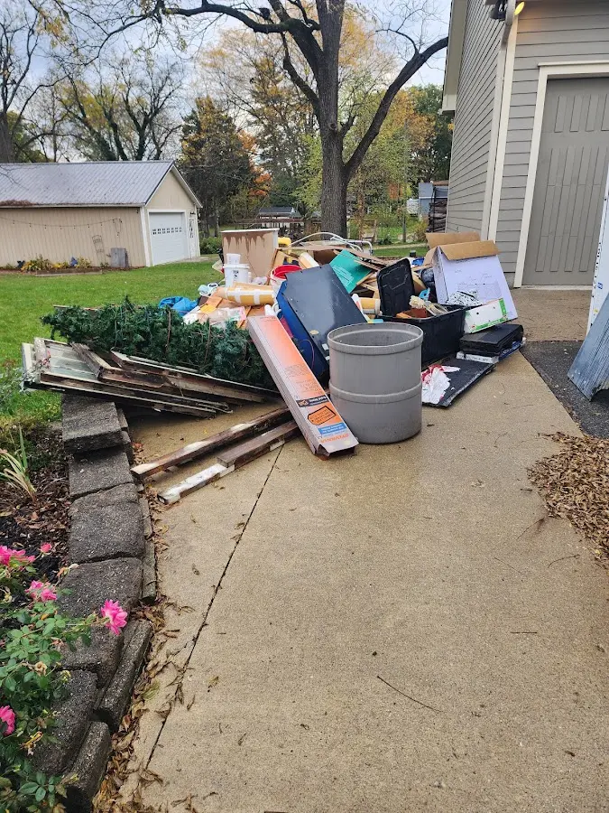 Dumpster being loaded with debris for 12 Yard Dumpster Rental in Athens